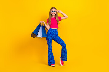 Full length photo of positive lady trendy outfit advertising low prices quality clothes empty space isolated on yellow color background