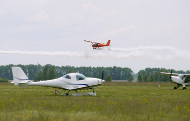 Light sport plane flying above the landing field