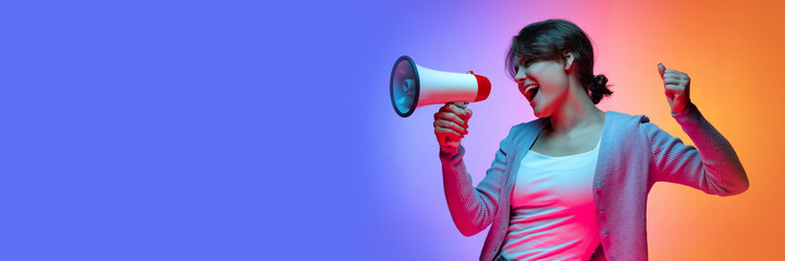 Emotional news. Young girl shouting in megaphone over gradient blue orange background in neon light. Cheering up. Banner, flyer. Concept of emotions, facial expression, sales, ad, fashion