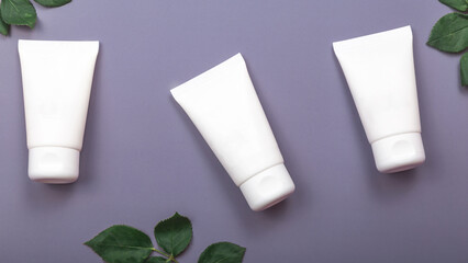 Set of skin care products on violet pastel background. Skin care concept.