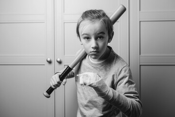 Teenager with broken arm. Boy holding baseball bat. Kid with broken hand after training. Sport time...