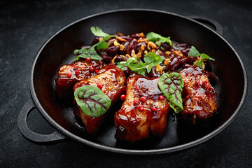 Grilled ribs in a sauce with beans, in a pan