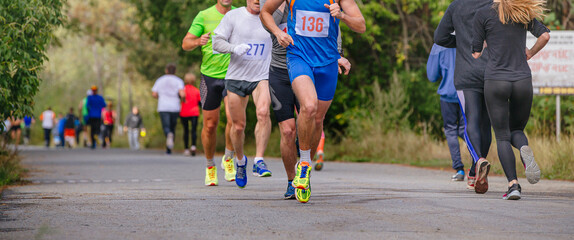 group male runners run marathon race in park