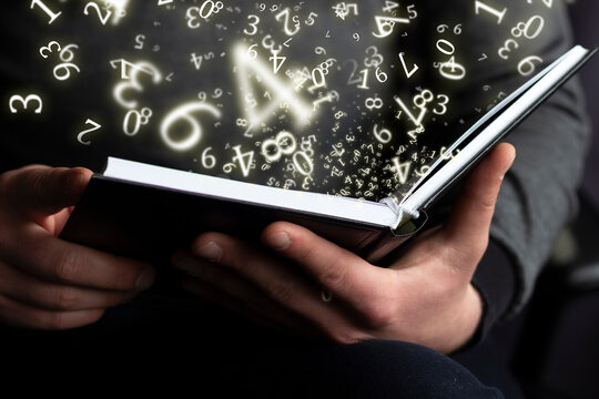 numerology, a man holds an open book in his hands, surrounded by numbers