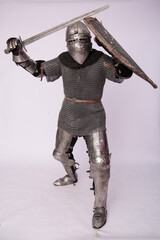 Romantic knight in armor with sword and helmet. Warrior in chain mail on a white background.