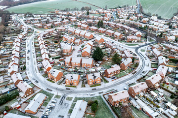Aerial view of snow covered rooftops of a suburban neighbourhood during the heating and energy...