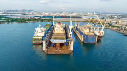 cargo container ship at dry dock concept maintenance service working in the sea. Insurance and...