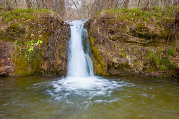 Fototapeta na wymiar closeup small waterfall on mountain river