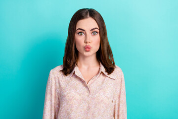 Fototapeta premium Photo of nice young lady funny facial expression air kiss dressed stylish smart casual look isolated on aquamarine color background