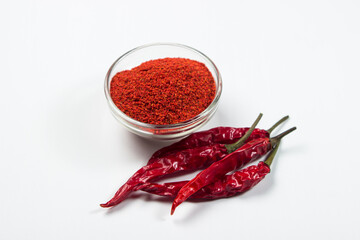 Dried chili peppers and ground pepper on a white background. hot seasoning