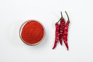 Dried chili peppers and ground pepper on a white background. hot seasoning