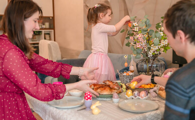 Happy family having fun with Easter decorations during lunch. Happy easter! Family enjoying Easter holiday