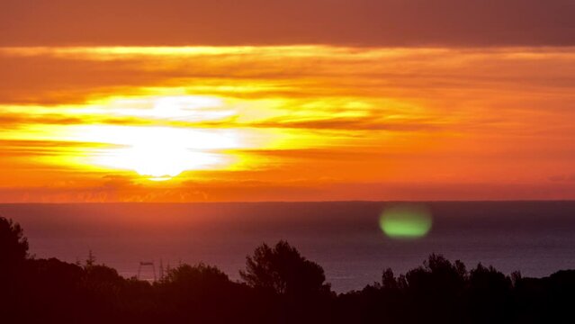 Time lapse of the sunrise over the Mediterranean sea, sharp sun with clouds, french riviera cote azur, Antibes, 4K