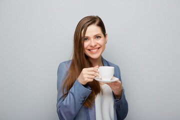 Business woman wearing suit drinking coffee.