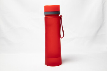 Red plastic thermos on a white background. Isolated object