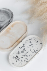 Handmade round concrete coasters with abstract creative terrazzo pattern. Granite shards. Colorful texture of stones and rocks. Neutral concrete terrazzo coasters. Recycled materials. Home Decor.