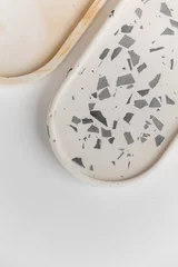 Rollo Handmade round concrete coasters with abstract creative terrazzo pattern. Granite shards. Colorful texture of stones and rocks. Neutral concrete terrazzo coasters. Recycled materials. Home Decor. © Anna