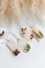Aroma sachet with dried flowers with coconut or organic soy wax. Close up on white background
