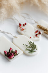 Aroma sachet with dried flowers with coconut or organic soy wax. Close up on white background