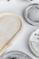 Hand cast round concrete coasters with terrazzo abstract creative pattern. Granite fragments. Stones and rocks color texture. Neutral Terrazzo Concrete Coasters. Recycled materials. Decor for home