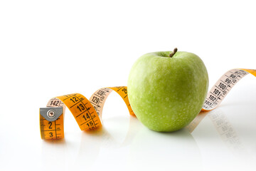 Healthy background with apple and tape measure and isolated background