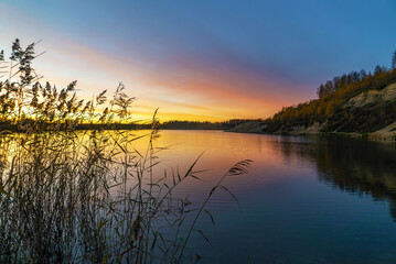 Naklejka na ściany i meble Beautiful sunset on the lake in the late evening .
