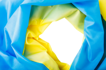 Fabric curved flag of Ukraine. yellow and blue Hole in the ukraine flag with torn sides.