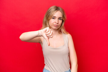 Young English woman isolated on red background showing thumb down with negative expression