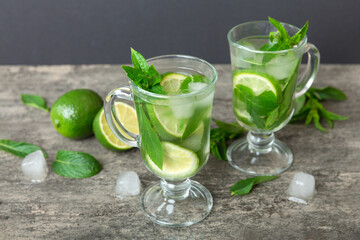 Fototapeta premium Mojito cocktail. Refreshing mojito cocktail with lime, lemon and mint in a tall glass with a stick