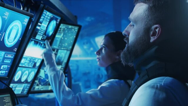 Team of astronauts in a space suits aboard the orbital station. A crew of cosmonauts piloting the spaceship. Man and woman in space. Galactic travel and science concept.