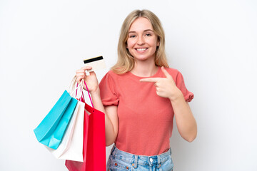 Young English woman isolated on white background holding shopping bags and a credit card