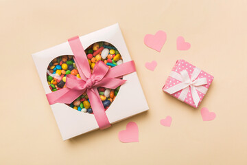 Valentine day composition: sweet candy, with gift boxes with bow and red felt hearts, photo template, background. Top View with copy space