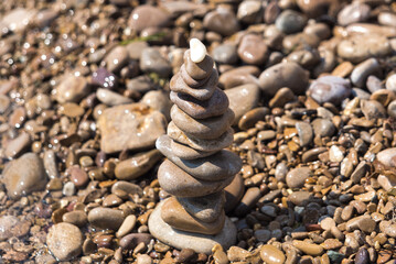 Fototapeta na wymiar cairn on the seashore, sea stones, seashore, pebbles on the seashore, meditation