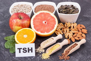 Inscription TSH with nutritious products and ingredients containing vitamins for healthy thyroid