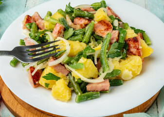 White plate with Belgian boiled potato salad and fork