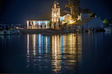 Fototapeta na wymiar KANONI, CORFU, GREECE - September 19, 2021:Illuminated night scene of Vlacherna monastery and Pontikonisi island, Kanoni, Corfu