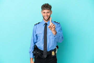 Young police blonde man isolated white on blue background showing and lifting a finger