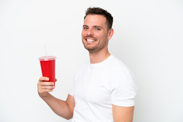 Young caucasian soda holding soda isolated on white background smiling a lot