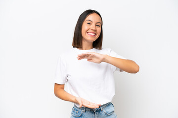 Young caucasian woman isolated on white background holding copyspace imaginary on the palm to insert an ad