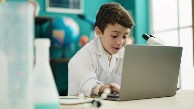 Adorable hispanic boy student having video call at laboratory classroom