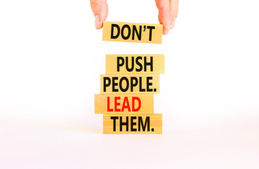 Push or lead people symbol. Concept words Do not push people lead them on wooden blocks. Beautiful white table white background. Businessman hand. Business Push or lead people concept. Copy space.