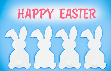 the concept of Easter, the silhouette of hares on a blue background with the inscription of a happy Easter. High quality photo