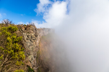 Fototapeta na wymiar Saint-Paul, Reunion Island - Cloud over Mafate cirque at Maido viewpoint