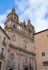 Fototapeta na wymiar Building of the former Real Colegio del Espíritu Santo named La Clerecia in Salamanca (Castile and Leon, Spain). Historic building in baroque style. Church with an impressive facade of three bodies.