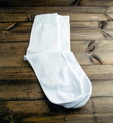 White cotton socks on a wooden table.