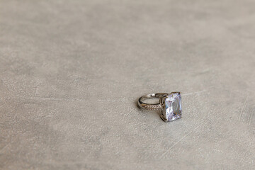 Will you marry me. Wedding ring on concrete stone grey background. Engagement marriage proposal...