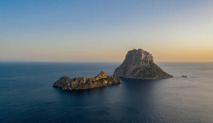 Es Vedra is an islet located on the island of Ibiza, calm blue sea and beautiful sky