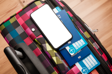 passport and a smart phone with a digital of a certificate of vaccination against the Covid-19 disease.