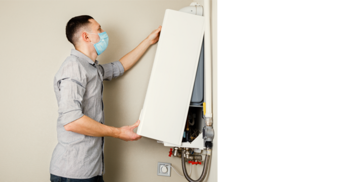 Plumber attaches Trying To Fix the Problem with the Residential Heating Equipment. Repair of a gas boiler