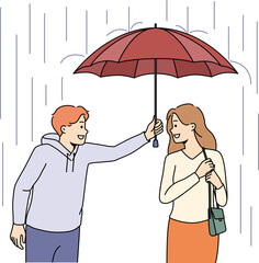 Caring man protect woman from rain with umbrella